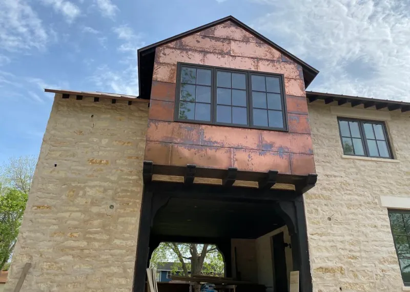 Copper metal panel facade on a stone building for Metal Roof Coating in Penitas